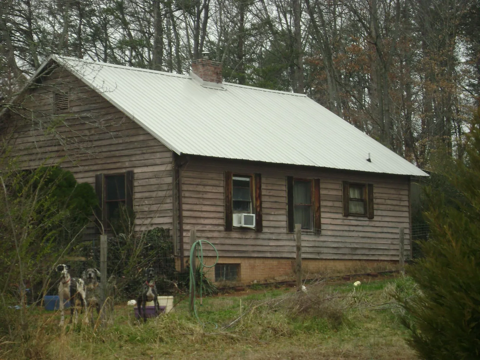 White metal roof on an old wood sided farmhouse, from a Metal Roof Installation job in Cross Plains